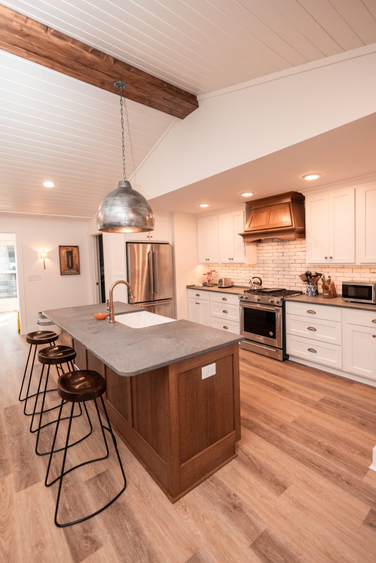 about 3 bars stools in custom kitchen; The home has a light and airy feel